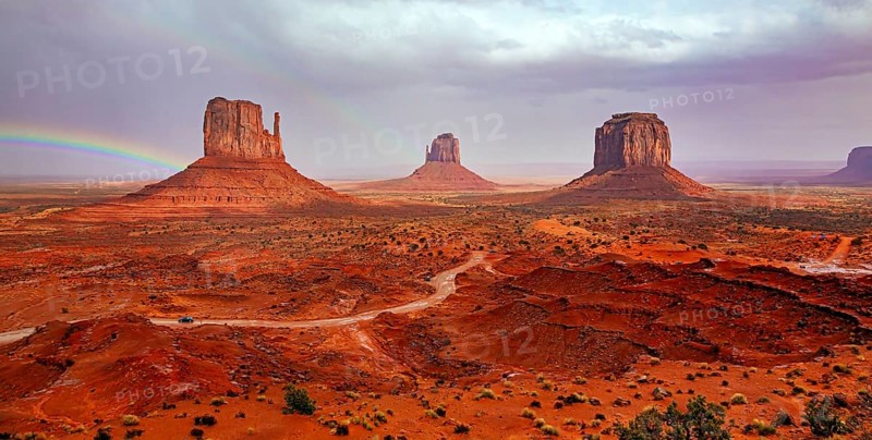 USA. Navajo Indian Reservations. The famous rock Mitten and the bright rainbow. Monument Valley is a unique geological formation in Arizona and Utah