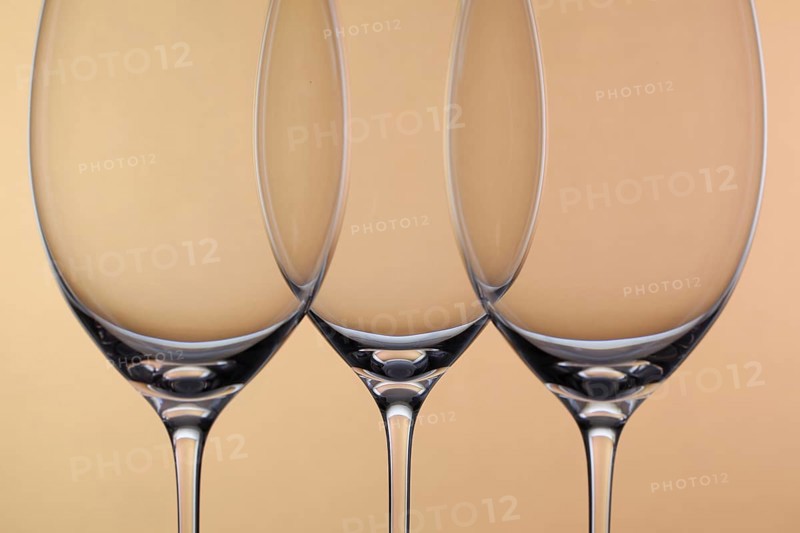 Three empty glasses of wine on a background