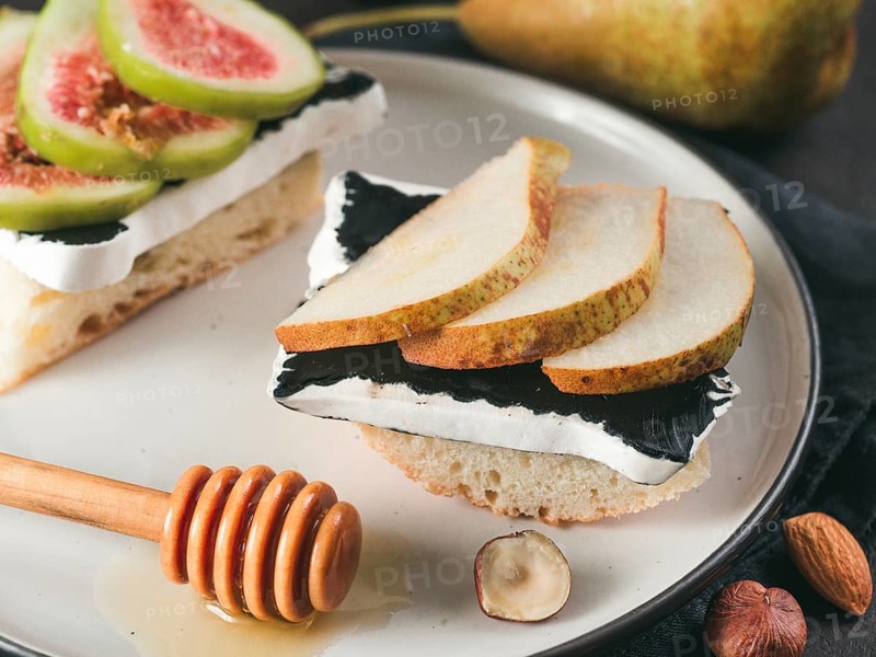 Toast with black camembert cheese and pears slices on plate. Healthy snack or breakfast idea and reciepe