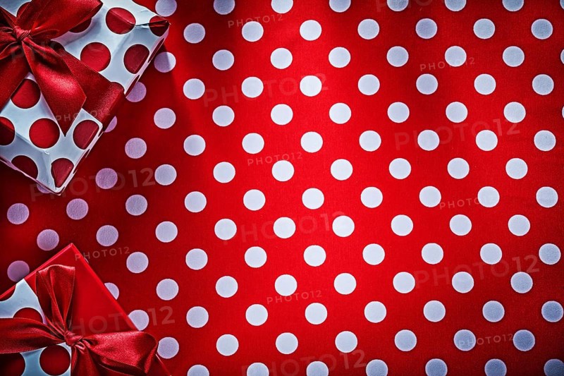 Decorated gifts on polka-dot red table cloth holidays concept