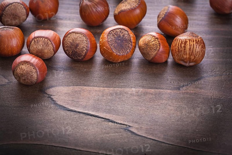 Set of hazelnuts on vintage wooden board food and drink concept