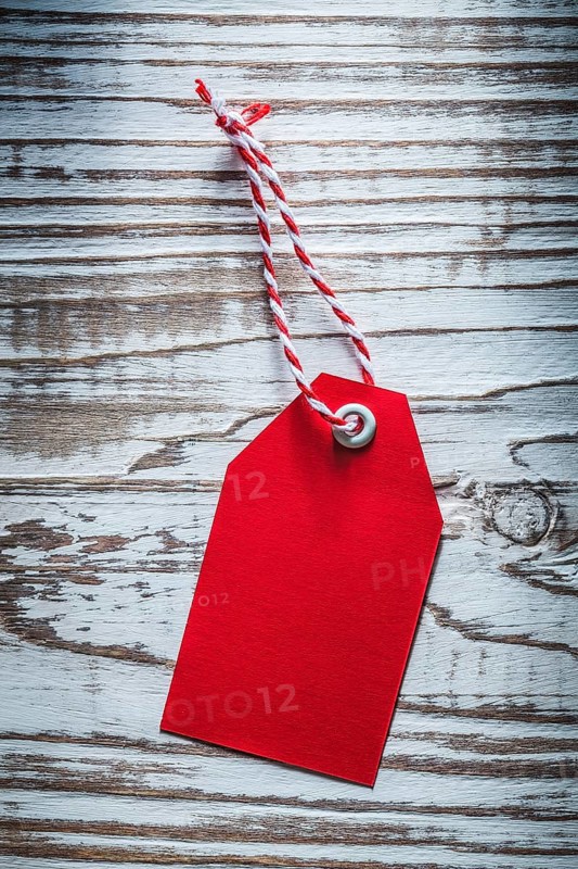 Red pricetag on vintage wooden board shopping concept