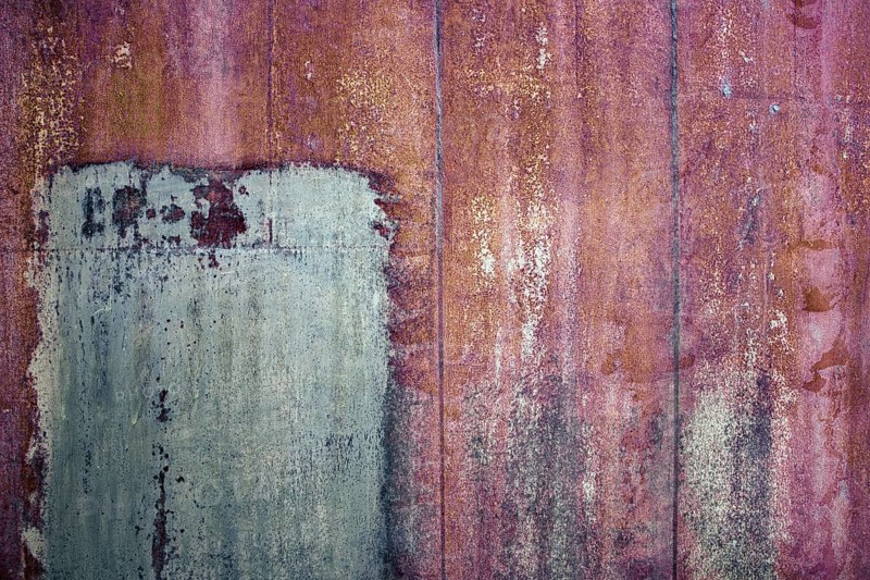 Rusty iron sheet with corrosion, selective focus, textured background