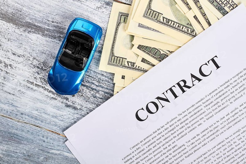 Car documents and currency. Conclusion of purchase agreement