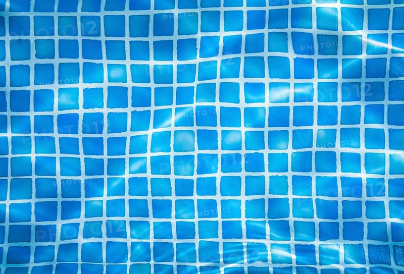 Vacation Abstract Background Of Water Ripples Over Swimming Pool Tiles