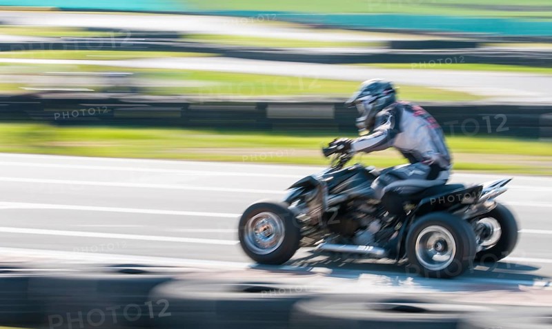 Unrecognised man is driving Go-kart with speed in the on a karting track