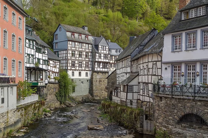 Picturesque houses along the Rur River in the historic center of Monschau, Germany