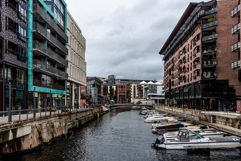 Oslo, Norway, August 11, 2019: Canal with boats in Tjuvholmen quarter, a new modern urban renewal with luxury housing in Central Oslo