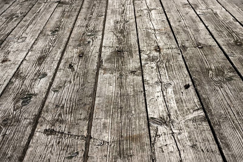 Weathered gray wooden floorboards as background photo