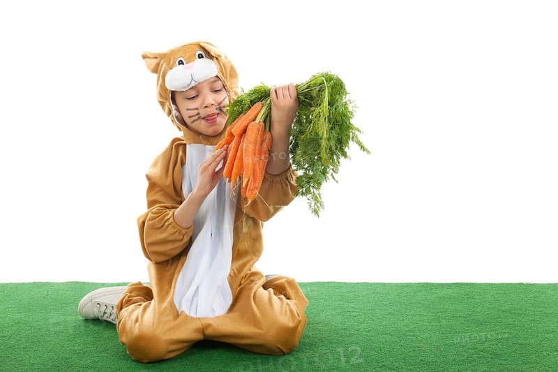Child dressed as easter hare with bunch carrots isolated over white background