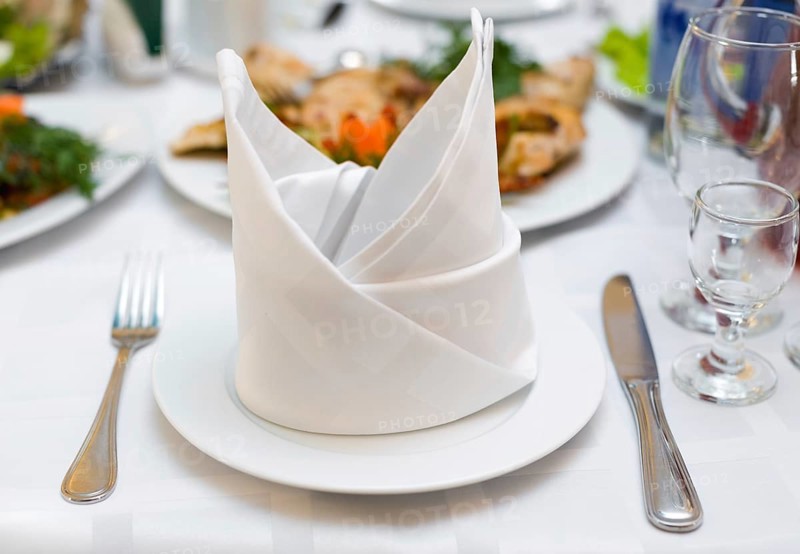 Place setting at laid restaurant banquet table