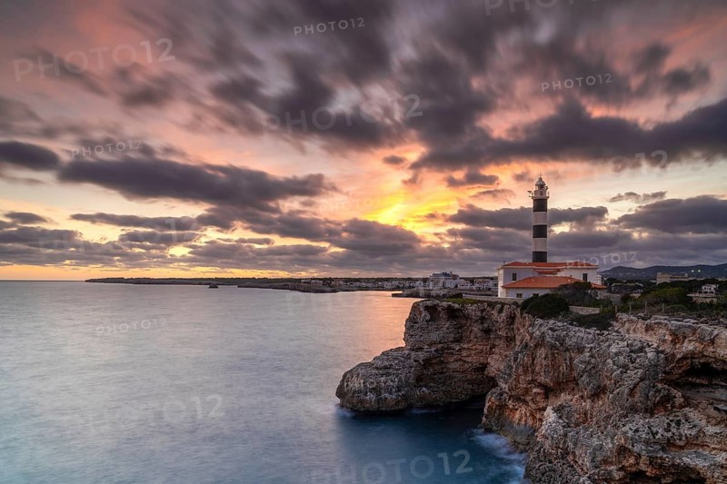 A view of the Portocolom Lighthouse in eastern Mallorca at sunset