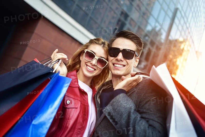 Portrait of a couple with shopping bags in the city.People, sale, love and happiness concept