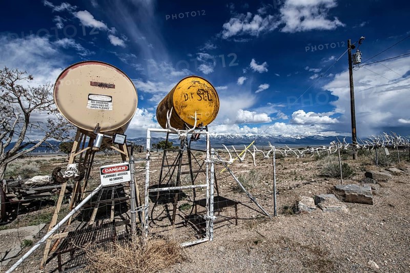 Truck stop with oil barrels and a fence of deer antlers, Highway 50, Loneliest Road in America, Ely, Nevada, USA