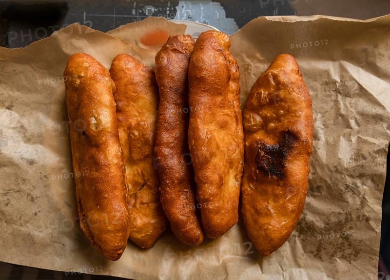 Fried pies lie on craft paper on the table