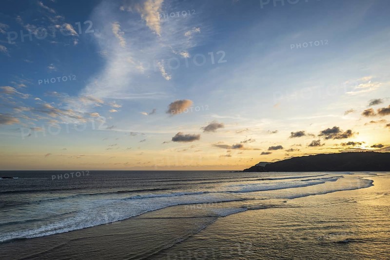 Beautiful sunset landscape at tropical beach in Lombok, Indonesia. Bright sunset landscape near Kuta beach area, Lombok, Indonesia