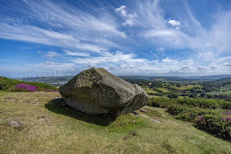 Large rock on a hill with sweeping views over a green landscape around Conwy and Conwy Castle on the edge of Snowdonia National Park, Conwy, Dwygyfylchi, Caernarfonshire, Conwy County Borough, Wales, United Kingdom