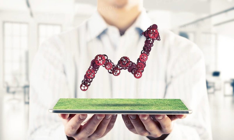 Close of businessman holding tablet with progressing graph. Mixed media
