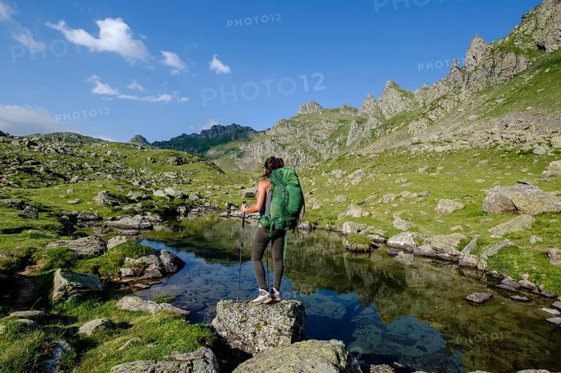 Hiker on Lac Bersau, Ayous lakes tour, Pyrenees National Park, Pyrenees Atlantiques, France