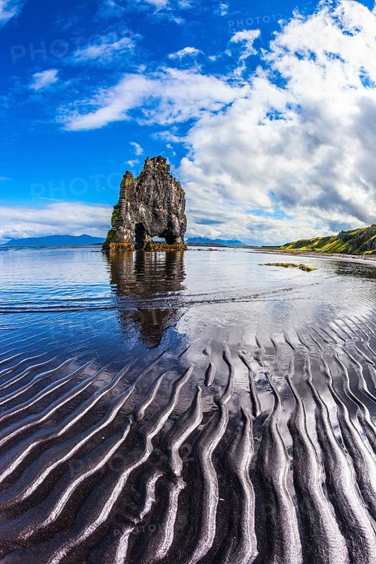 Ocean tide at sunset. The north coast of Iceland. Rock Hvitserkur on the sea beach in the form of a huge elephant. The concept of extreme northern tourism