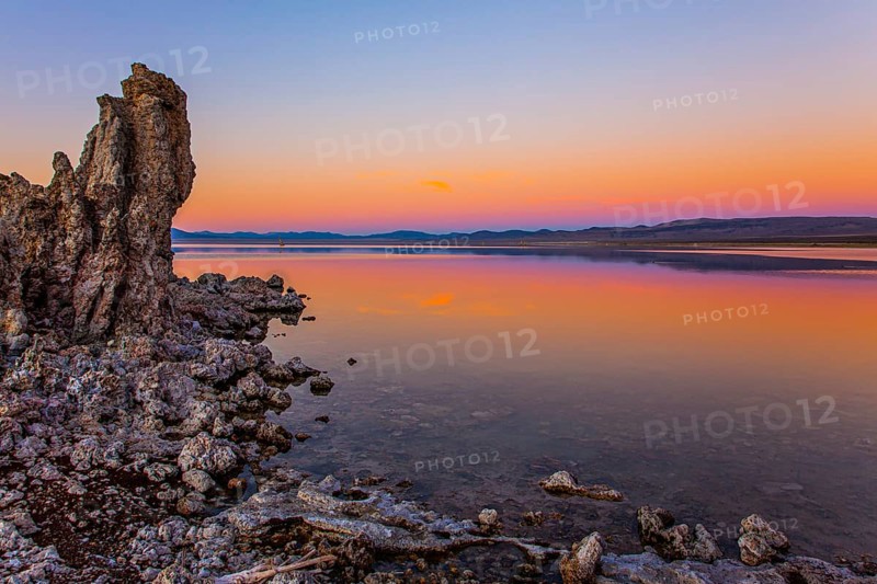 Magic sunset on the lake. Lime-tuff towers of bizarre shapes rise from the bottom of the lake. The natural wonder of the world is Lake Mono. Mono Lake is a salt lake in California