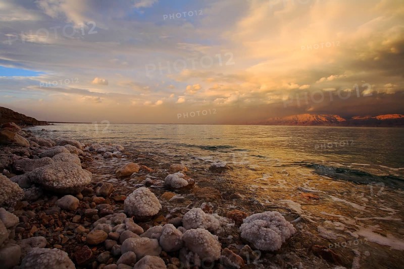 Coast of the Dead Sea in Israel in a spring thunder-storm. The coastal stones covered by salty adjournment