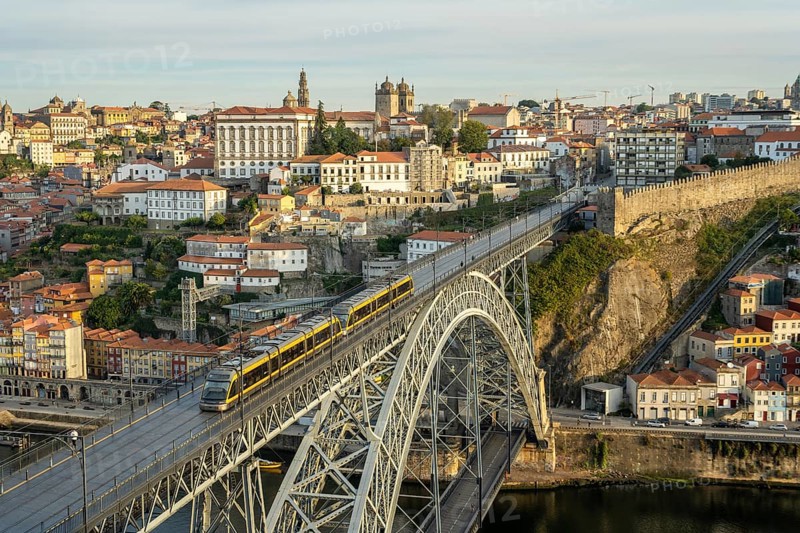 Porto City, Douro River and Dom Luis Bridge I with Tram in Morning. View from Tourist Viewpoint Miradouro da Serra do Pilar. Portugal. Medium Telephoto Shot