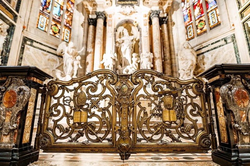 Carved gates with gilding in front of the altar of St. John in the Duomo. Milan, Italy.