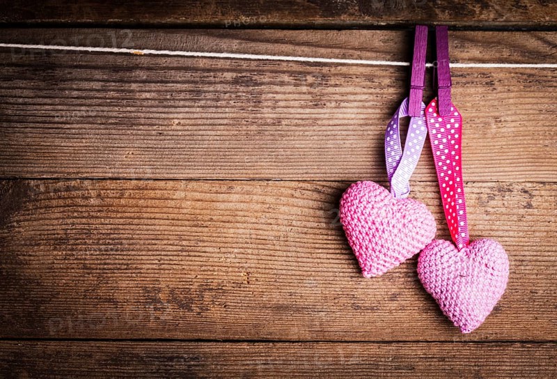 Crochet valentine hearts handing on the rope. Valentine's day greeting card. Love concept