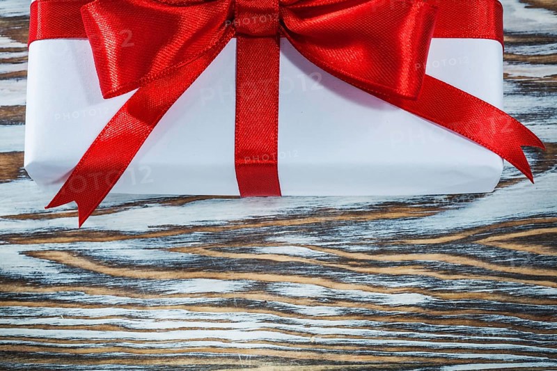 Red gift box on wooden background horizontal view