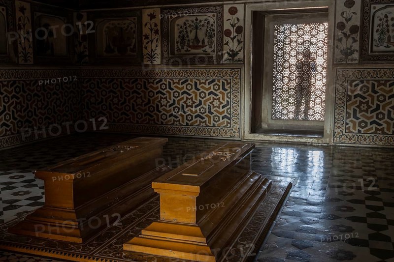 Tomb of I'timad-ud-Daulah, Mirza Ghiyas Beg, a high official in the Mughal Empire. Surrounded by charbag, the Indo-Persian style garden, the white marble mausoleum decorated with pietra dura stone inlay technic is often called Baby Taj or Bachcha Taj. It is a fine example of the Mughal architecture, and was one of the inspirations for the design of the Taj Mahal. Interior with two sarcophagi and a jali, a carved latticed stone screen in the window. Agra, Uttar Pradesh, India