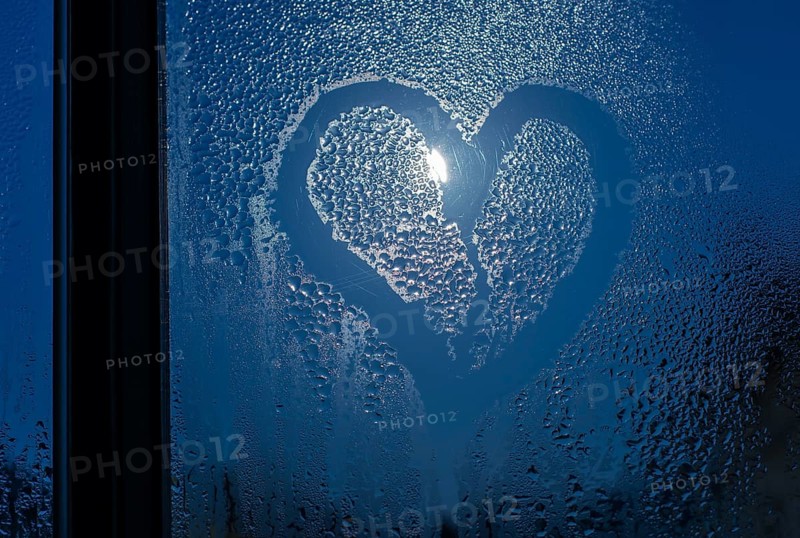Moonlight through the window. Sweaty glass and heart shape