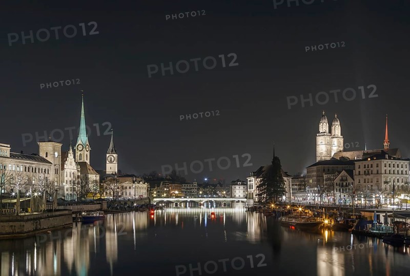 Limmat river with view of churchs in Zurich in evening, Switzerland