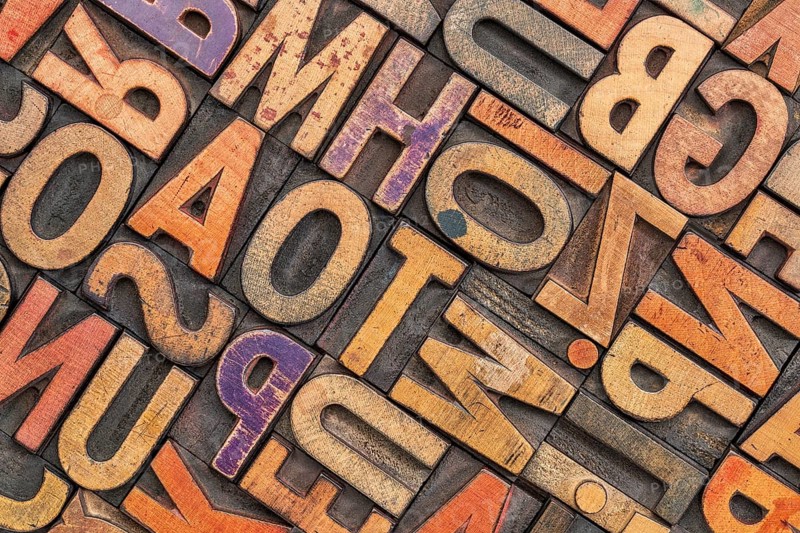 Wood type alphabet abstract with a grunge texture - letterpress printing blocks stained by color inks