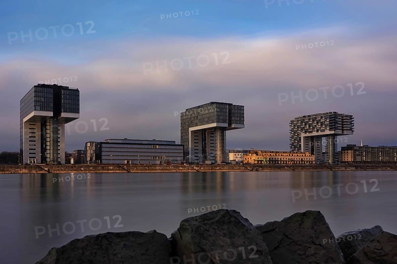 View over the Rhine with crane houses, sunrise, long exposure, Cologne, Germany