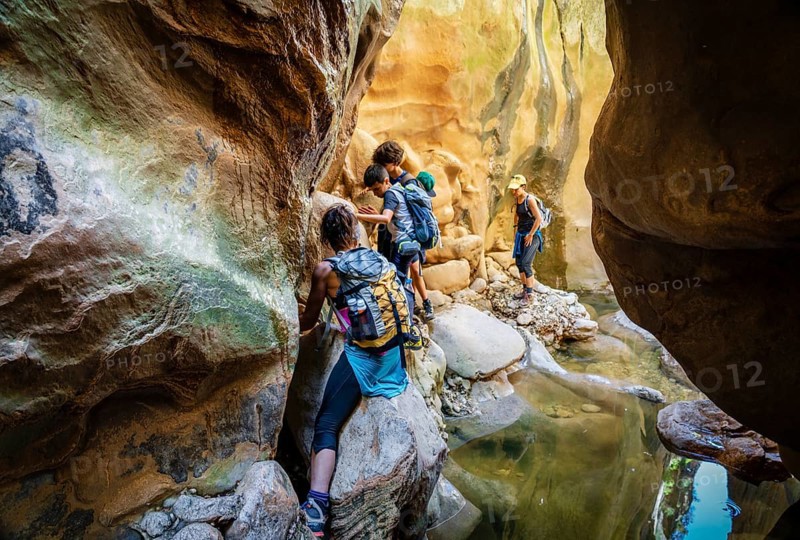 Walkers dodging waterlogged stretches, Torrent de Pareis, Sa Calobra, Majorca, Balearic Islands, Spain
