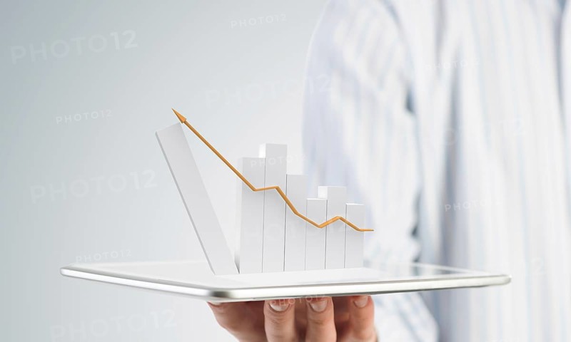 Businessman hand holding tablet with finance graph on screen