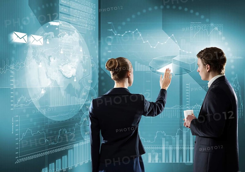 Rear view of businessman and businesswoman working with virtual panel interface