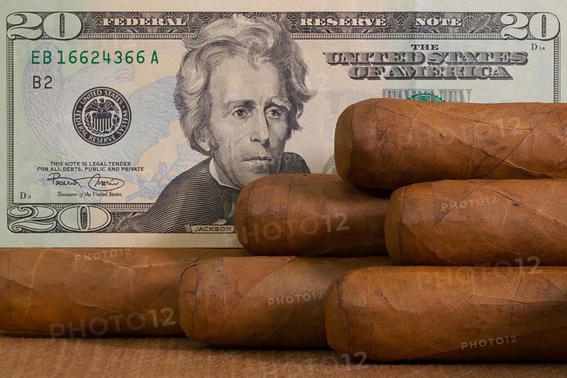 Luxury Cuban cigars with US dollar banknote on the wooden table
