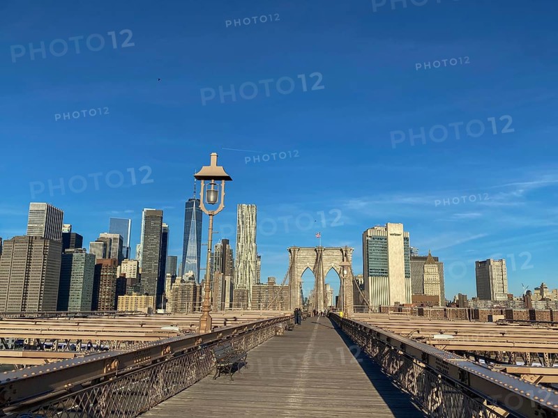 Straight view of the Brooklyn Bridge with skyscrapers and clear sky in the background, New York, USA