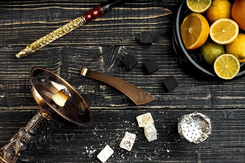 Stylish Smoking hookah and basket with lemon, lime and orange on wooden background. Top view. Flat lay. Copy space. Still life