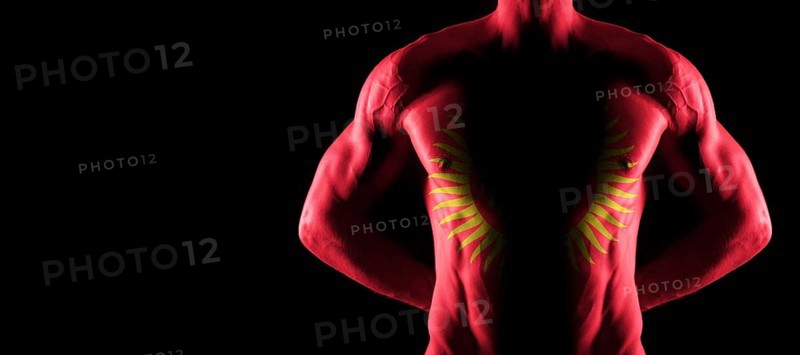Kyrgyzstan flag on muscled male torso with abs, black background