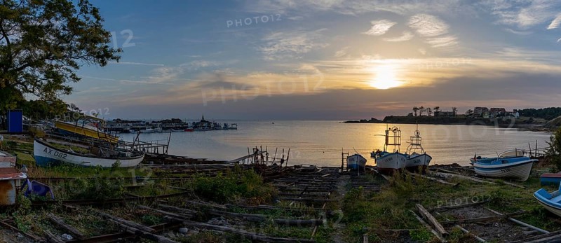 Athopol, Bulgaria, 23 October, 2022: panorama view of the boat ramps and small fishing boats in Athopol harbor on the Black Sea at sunrise