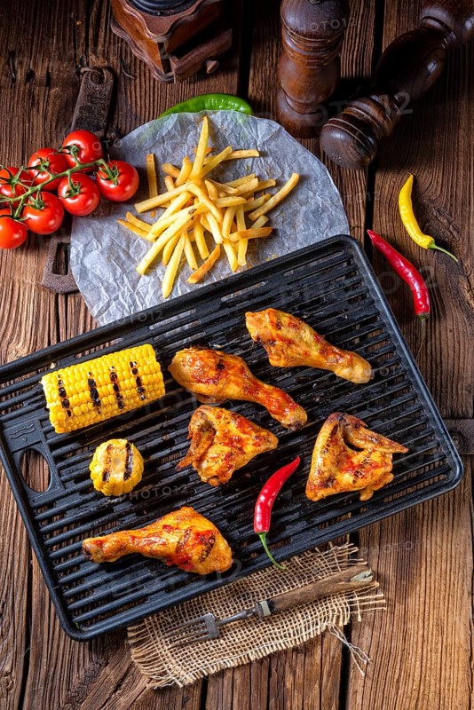 Rustic Grilled chicken wings, legs, and spicy corn