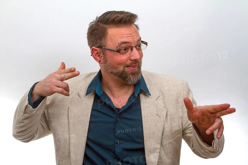 Young man points with finger on light background