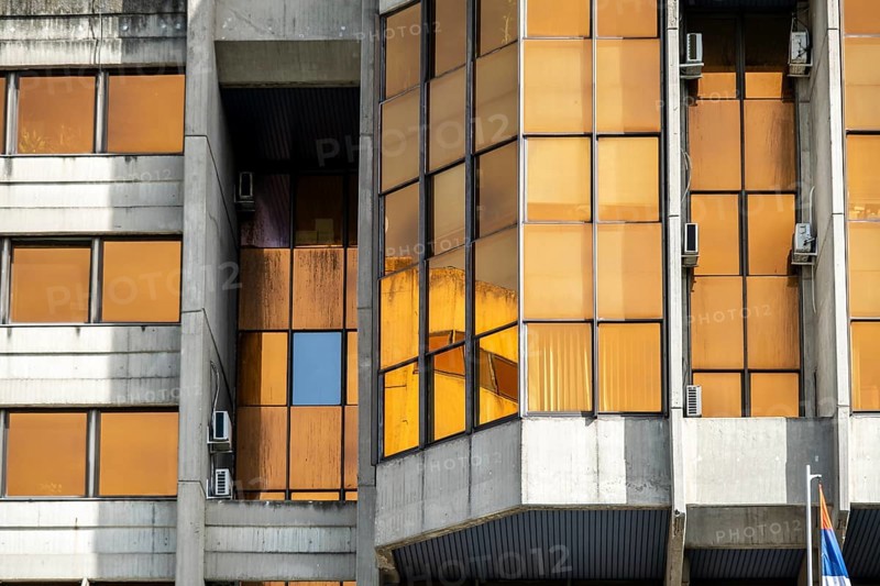 Brutalist government building with orange-coloured windows in Belgrade