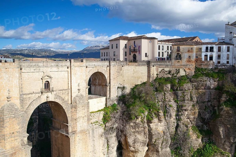 View of buildings in new town from other side of the 18th century bridge over the 300 ft Tajo Gorge in Ronda Spain