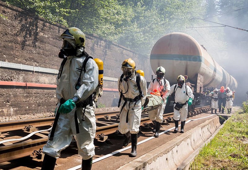 Sofia, Bulgaria - May 19, 2015: A team working with toxic acids and chemicals is saving people from a chemical cargo train crash. Teams from Fire department are participating in an emergency training with spilled toxic and flammable materials