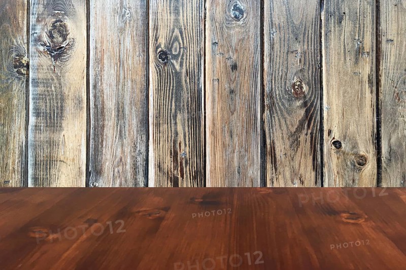 Old brown oak wooden table on the blurry wood wall background, wood table