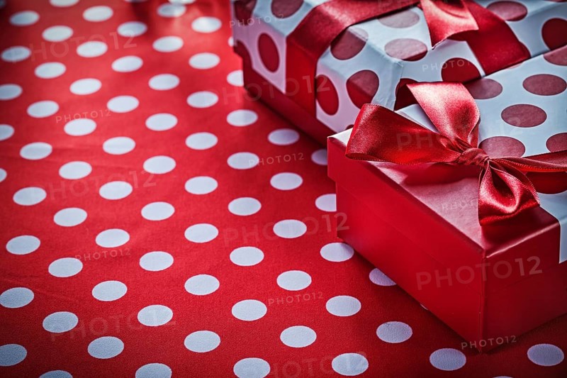 Christmas gifts on polka-dot red textile celebrations concept